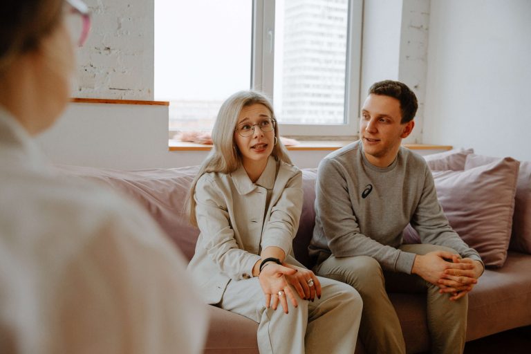 man and woman speaking with a counselor