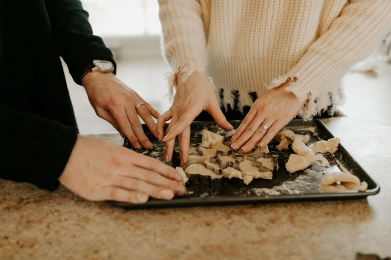 man and woman making cookies