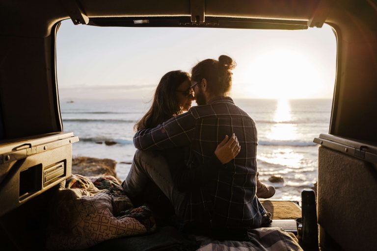 man and woman watching sunset